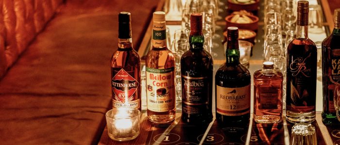 bottles of whisky lined up on table for a whisky tasting experience