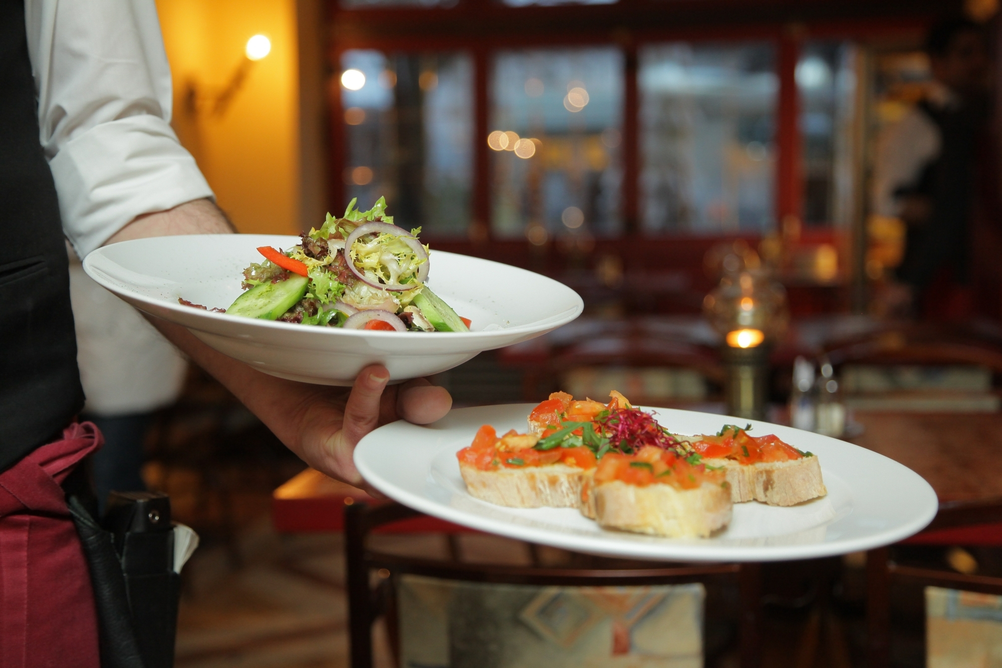 Waiter holding plates of food