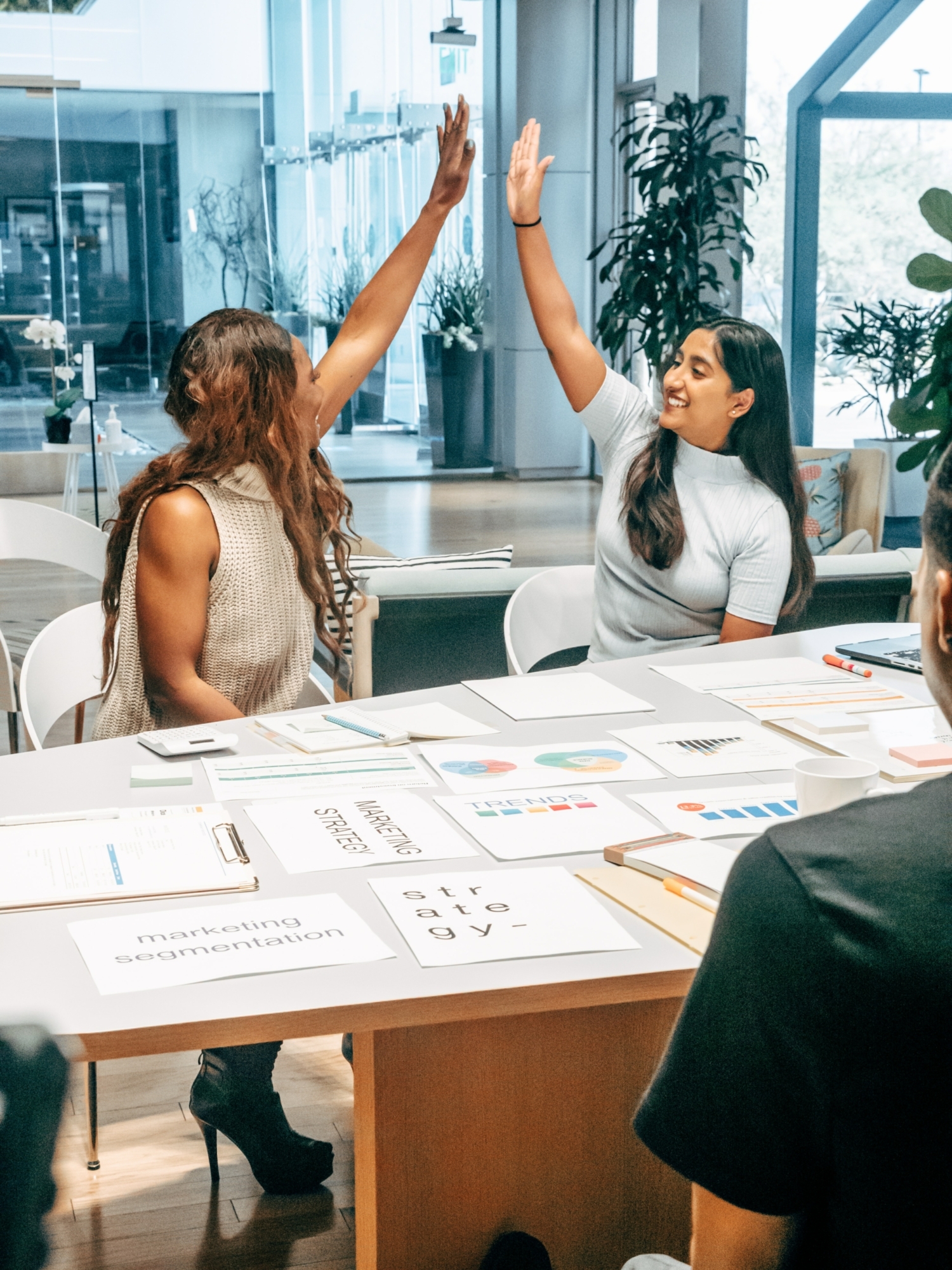 Women high fiving in office