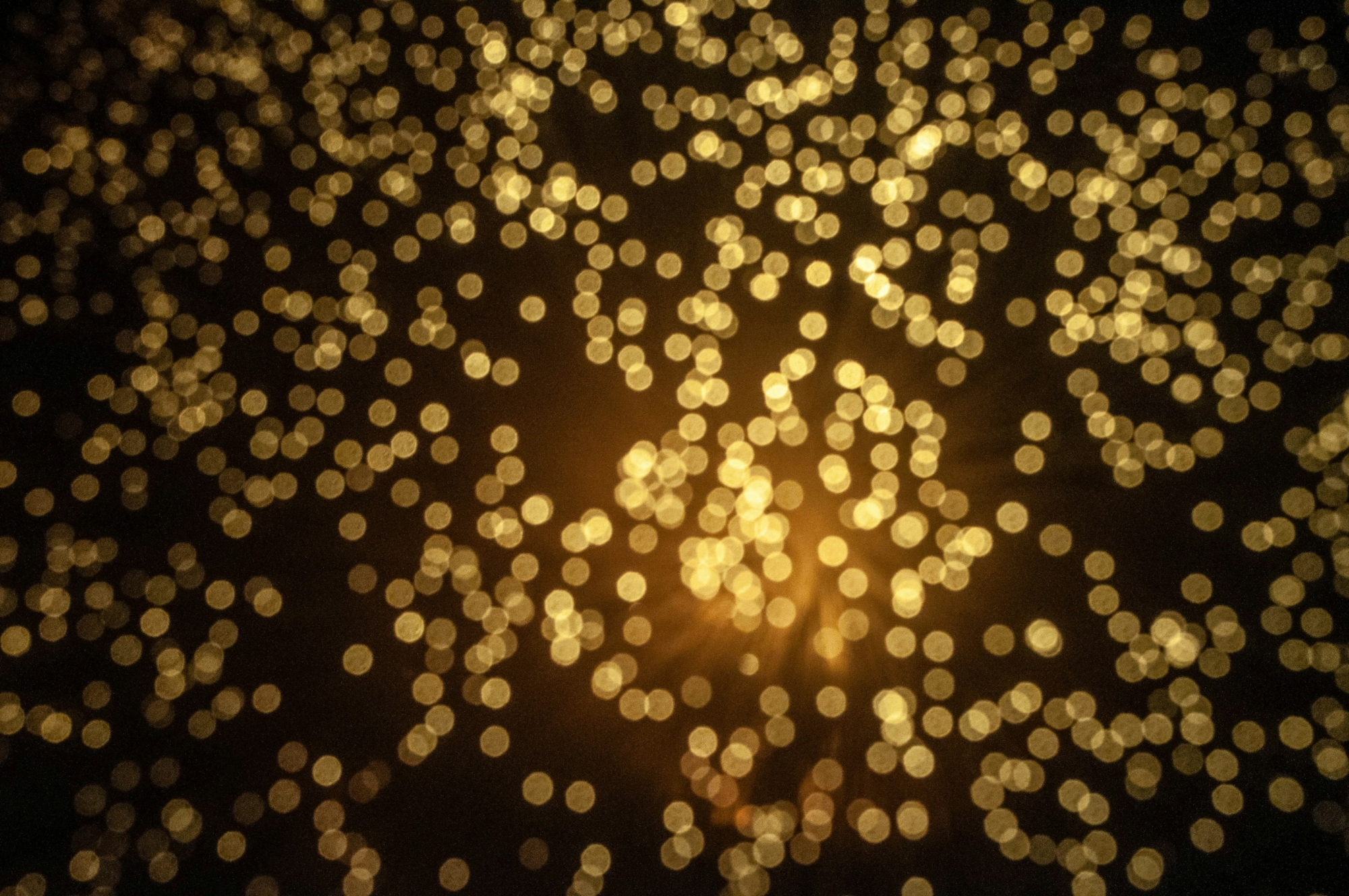 gold dots against a black background