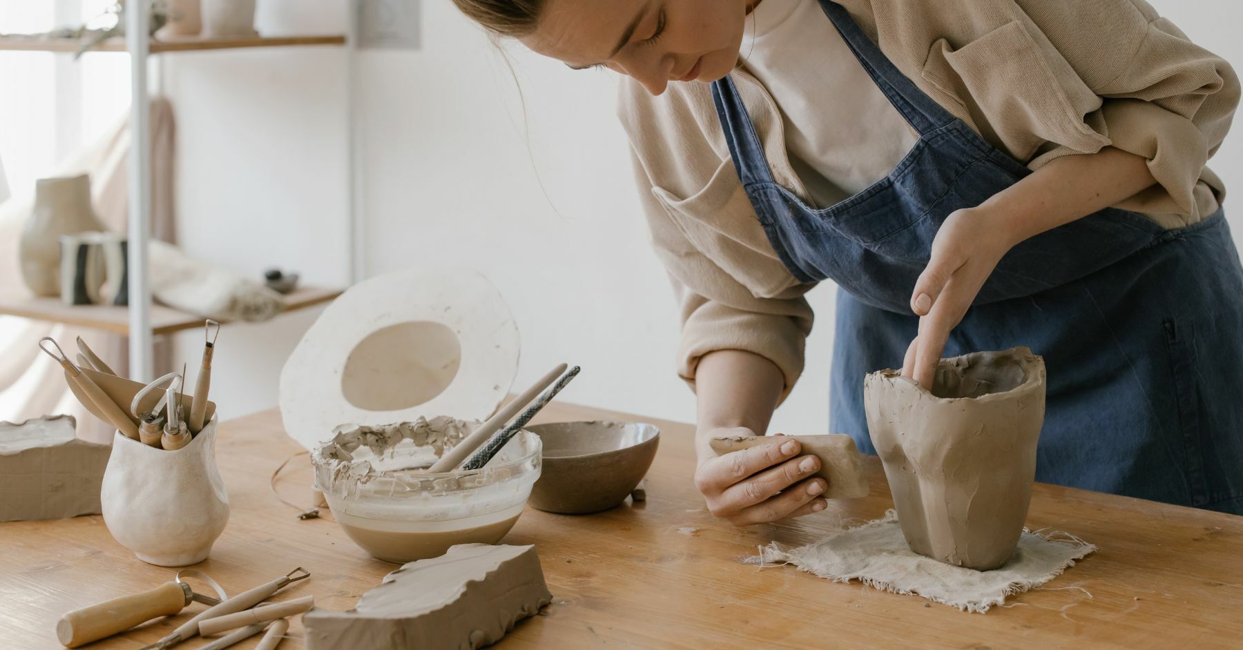 women making something out of clay on a pottery experience day